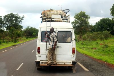 Rear view of vehicle on street against sky