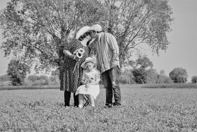 Full length of mother and daughter on field