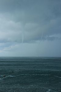 Scenic view of sea against storm clouds