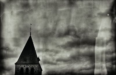 Low angle view of tower amidst buildings against sky