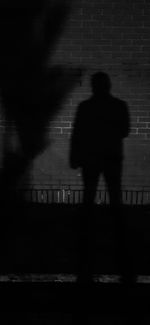 Rear view of silhouette person walking on road at night