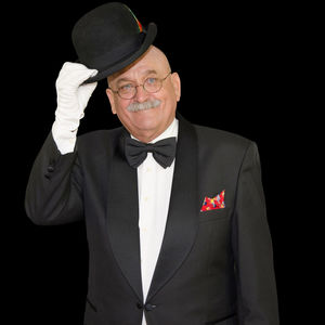 Portrait of man wearing hat against black background