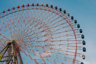 Low angle view of ferris wheel against sky