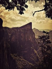 Scenic view of mountains against cloudy sky