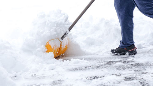 Low section of man skiing on snow