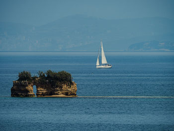 Sailboat sailing on sea against sky