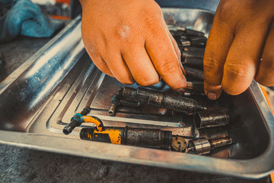 Close-up of man working on metal