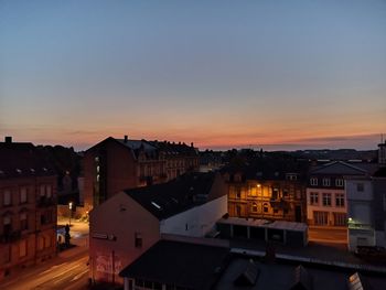 High angle view of illuminated buildings against sky at sunset