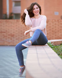 Portrait of a smiling young woman sitting outdoors