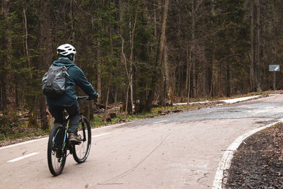 Man riding bicycle on road