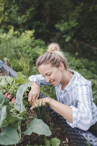 Woman holding food on plant