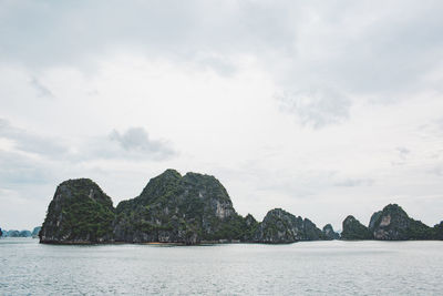 Rock formations in sea against sky