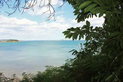 Scenic view of sea against cloudy sky