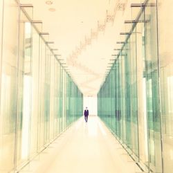 Rear view of woman walking in corridor