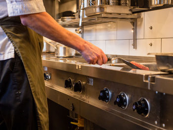 Close-up of chef preparing food in restaurant kitchen