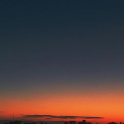 Scenic view of sea against clear sky at sunset