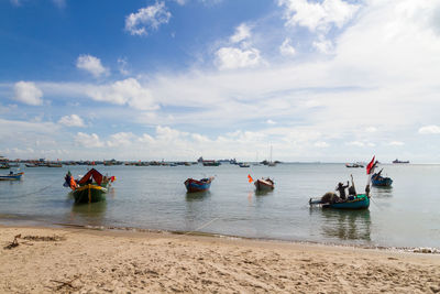 Boats on sea against sky