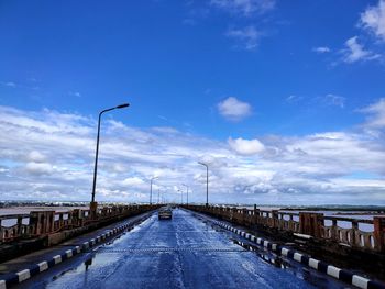 Empty road against blue sky