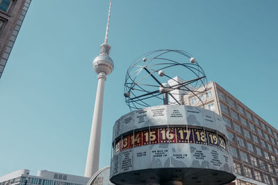 Low angle view of communications tower against sky