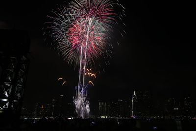 Low angle view of firework display at night