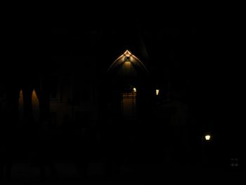 Illuminated building against sky at night