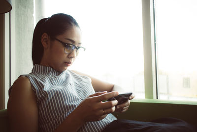 Midsection of man using mobile phone