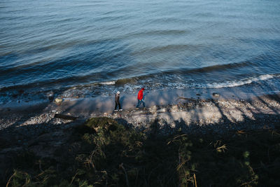 High angle view of people standing on beach