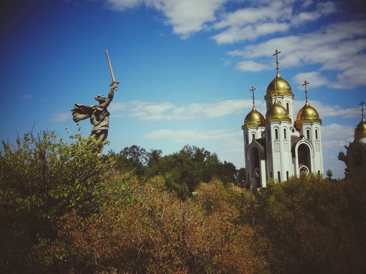 religion, place of worship, church, sky, spirituality, architecture, building exterior, built structure, low angle view, cross, cloud - sky, cathedral, history, tree, cloud, old, outdoors, no people