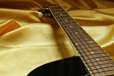 Close-up of guitar on fabric