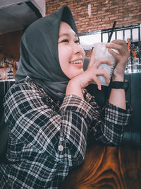 Portrait of young woman drinking glasses