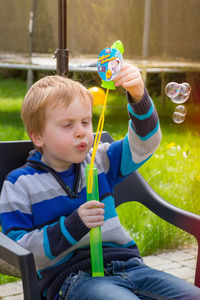 Boy playing with bubbles