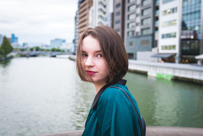 Portrait of young woman in river