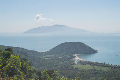 Scenic view of sea and mountains against sky