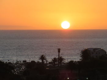 Scenic view of sea against romantic sky at sunset