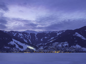 Scenic view of snowcapped mountains against cloudy sky