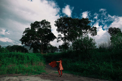 Full length of woman standing on field