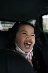 Portrait of happy boy in car