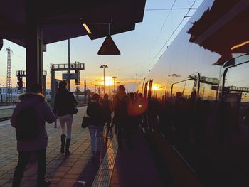 Group of people in city at sunset