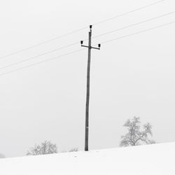 Low angle view of power lines against sky
