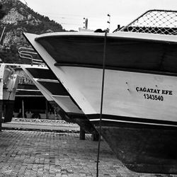 Side view of boats moored in water