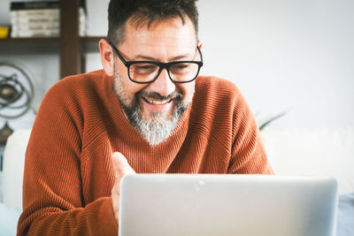 Young man using laptop at home