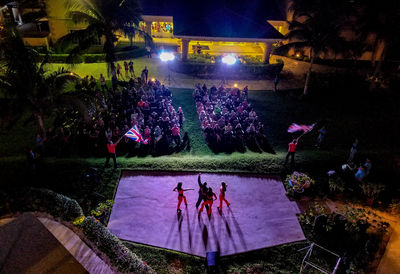 High angle view of people in swimming pool at night