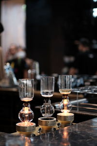 Close-up of wine glasses on table