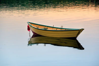 Side view of boat moored in calm lake