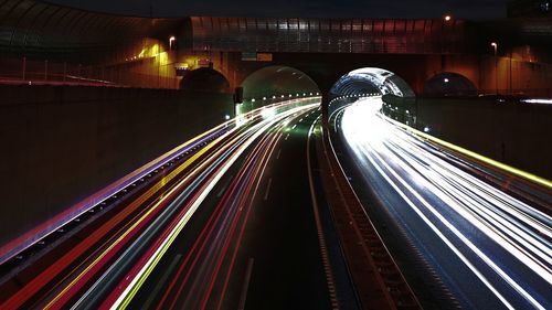 Light trails on road in illuminated tunnel