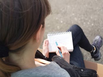 Midsection of woman reading book