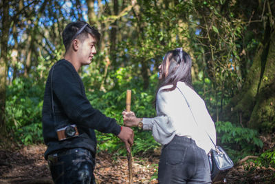 Couple standing in forest