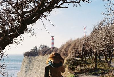 Woman overlooking bare trees