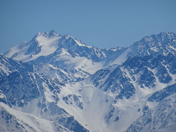 Scenic view of snowcapped mountains against clear sky