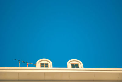 Low angle view of building against clear blue sky